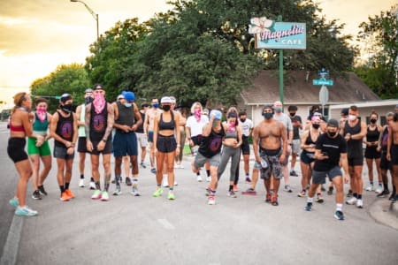 Group of masked runners gathered near Magnolia Cafe