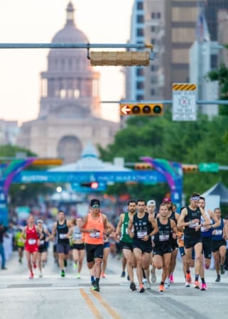Runners racing past capitol dome on street