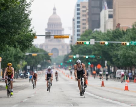 Cyclists racing down street toward capitol dome