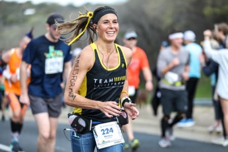 Smiling female runner at marathon race Smiling female runner at marathon race
