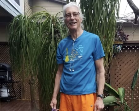 Smiling man in blue shirt and orange shorts Smiling man in blue shirt and orange shorts