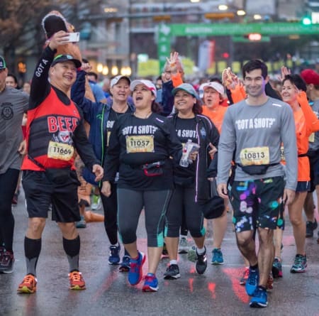 Group of runners smiling during a road race Group of runners smiling during a road race