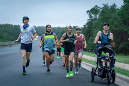 Group of runners jogging with a stroller