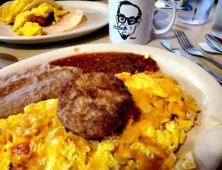 Cheesy scrambled eggs with sausage and beans