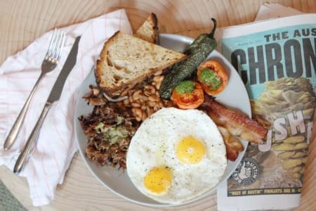 Breakfast plate with fried eggs, bacon, toast