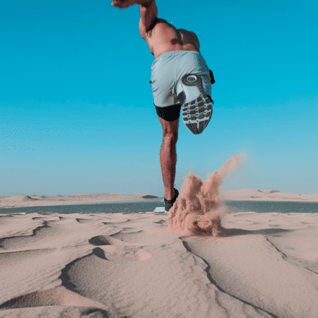 Runner sprinting across sandy desert dunes