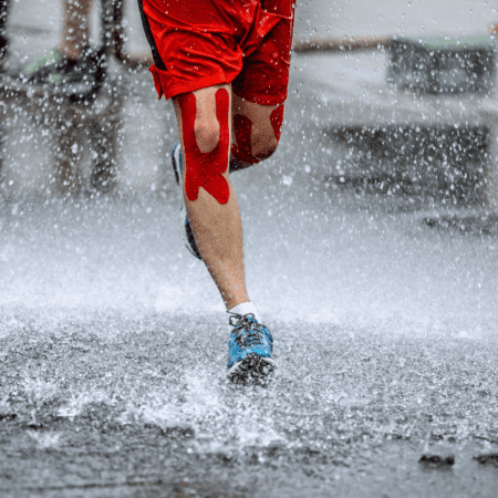 Runner's legs splashing through heavy rain