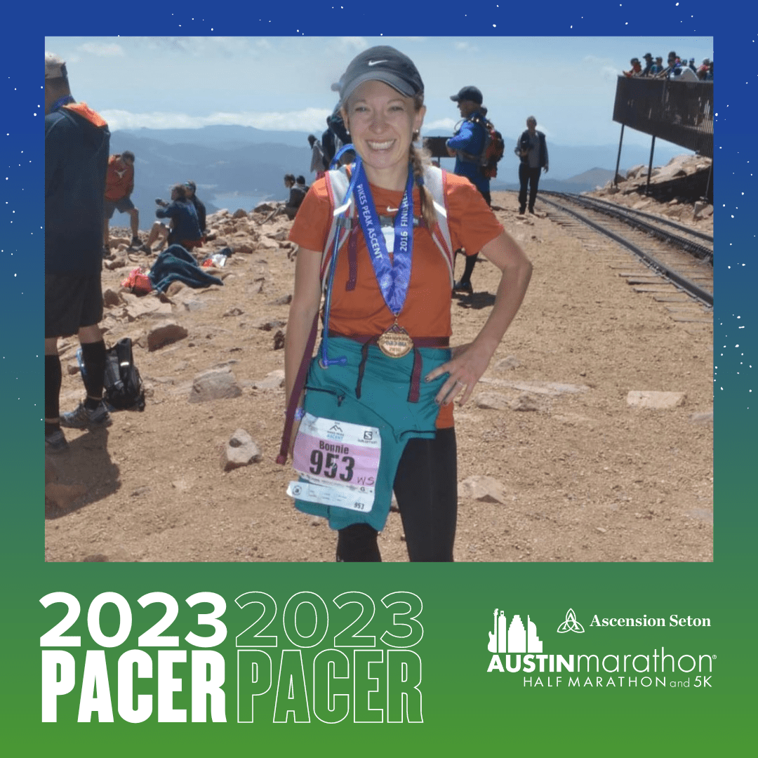 Smiling runner with medal on mountain summit Smiling runner with medal on mountain summit