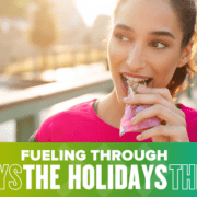Young woman biting into granola bar outdoors