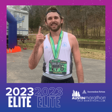 Austin Marathon runner with medal pointing upward