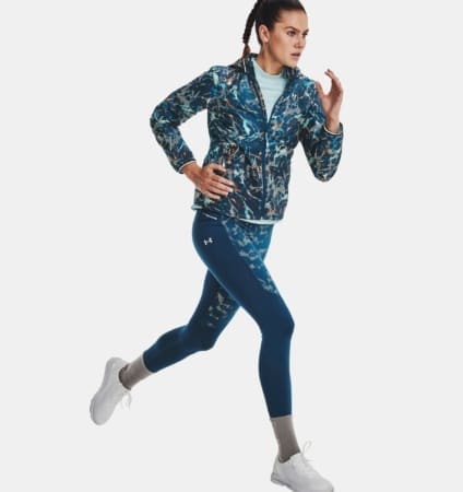 Woman running in blue patterned jacket and leggings Woman running in blue patterned jacket and leggings