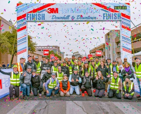 Group at marathon finish line with confetti