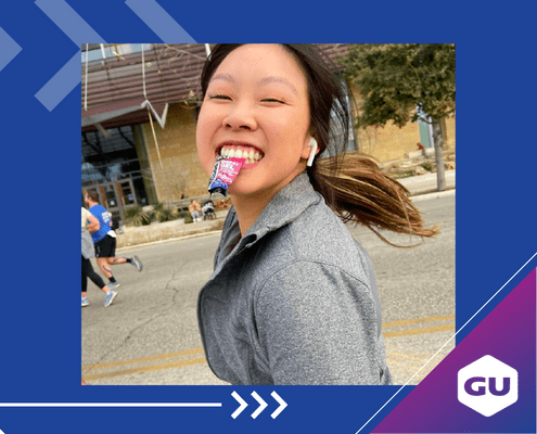 Runner smiling with energy gel in mouth