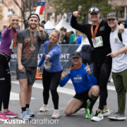 Austin Marathon finishers posing with medals