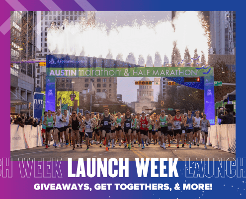 Runners starting under Austin Marathon banner with fireworks