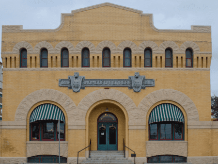 Historic yellow brick building with arched entrance Historic yellow brick building with arched entrance