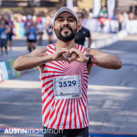 Runner making heart gesture at Austin Marathon finish Runner making heart gesture at Austin Marathon finish