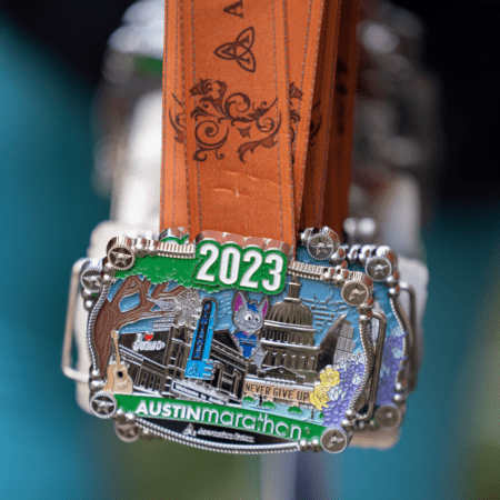 2023 Austin Marathon medal on orange ribbon 2023 Austin Marathon medal on orange ribbon
