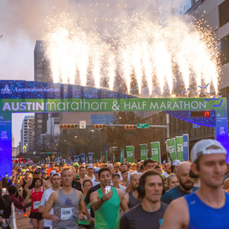 Runners at Austin Marathon starting line with fireworks