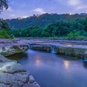 Twilight river with small cascading rock waterfalls