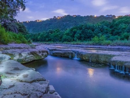 Twilight river with small cascading rock waterfalls Twilight river with small cascading rock waterfalls
