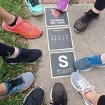 Group running shoes around start line marker Group running shoes around start line marker