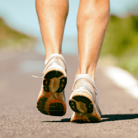 Close-up of runner's shoes on paved road Close-up of runner's shoes on paved road
