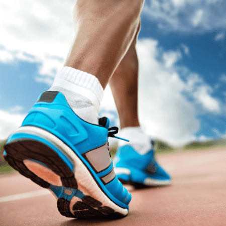 Close-up blue running shoes on track Close-up blue running shoes on track