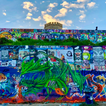 Colorful graffiti wall with green dragon mural