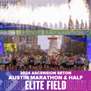 Runners starting Austin Marathon with fireworks overhead