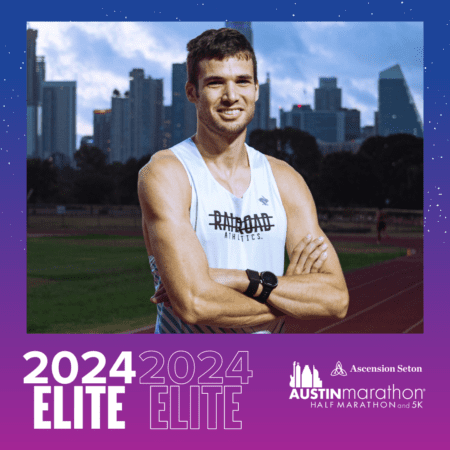Smiling male runner on track with skyline