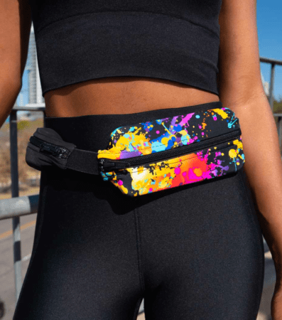 Colorful paint-splatter fanny pack on waist