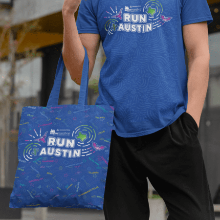 Person wearing Run Austin shirt with matching tote