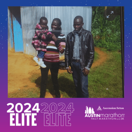 Family of three posing by corrugated metal building