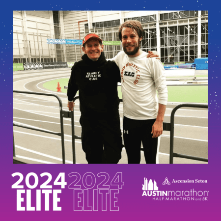 Two athletes smiling on indoor track with banner