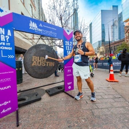 Smiling runner strikes gong at Austin marathon Smiling runner strikes gong at Austin marathon