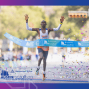 Runner crossing finish line at Austin Marathon