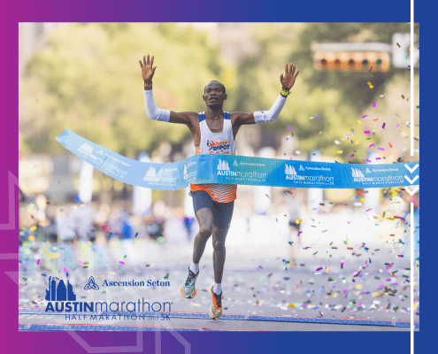 Runner crossing finish line at Austin Marathon