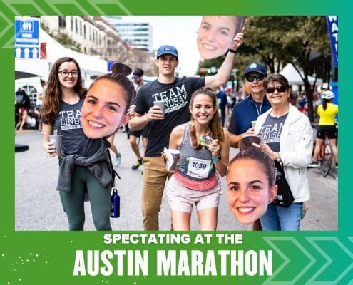 Spectators with oversized face cutouts at Austin Marathon