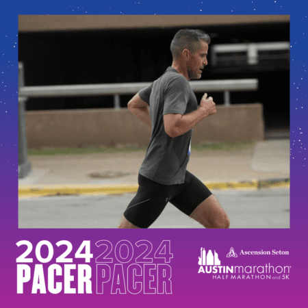 Male marathon pacer running along city street