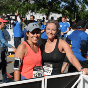 Two smiling women runners at race finish Two smiling women runners at race finish