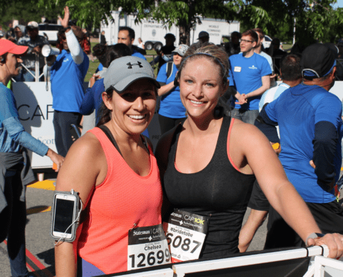 Two smiling women runners at race finish