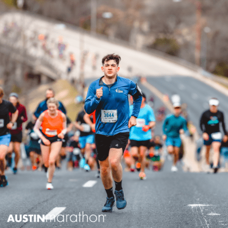 Runner in blue leading Austin Marathon pack