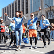 Runners celebrating at Austin Marathon finish line