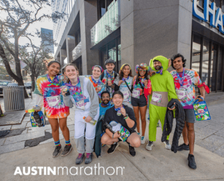 Group of colorful Austin Marathon runners smiling