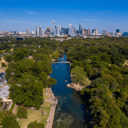 Aerial view of river through park to skyline