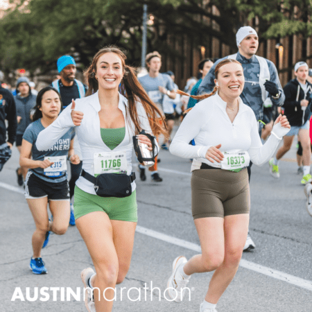 Two women, wearing athletic gear and bib numbers 11766 and 16313, smile and run in a marathon in Austin. The woman on the left gives a thumbs-up. Other runners are visible in the background. "Austin Marathon" is written at the bottom of the image, dispelling any marathon myths with their joyful presence.
Austin Marathon Half Marathon & 5K Two women, wearing athletic gear and bib numbers 11766 and 16313, smile and run in a marathon in Austin. The woman on the left gives a thumbs-up. Other runners are visible in the background. "Austin Marathon" is written at the bottom of the image, dispelling any marathon myths with their joyful presence.
Austin Marathon Half Marathon & 5K
