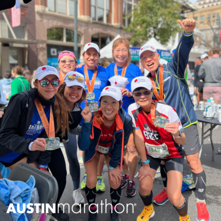 A group of smiling marathon runners proudly show their medals after completing the Austin Marathon. They are standing together in a celebratory pose, wearing athletic gear and caps. The background features event tents and spectators, debunking any myths about the difficulty of running such a race. The Austin Marathon logo is visible at the bottom. Austin Marathon Half Marathon & 5K A group of smiling marathon runners proudly show their medals after completing the Austin Marathon. They are standing together in a celebratory pose, wearing athletic gear and caps. The background features event tents and spectators, debunking any myths about the difficulty of running such a race. The Austin Marathon logo is visible at the bottom. Austin Marathon Half Marathon & 5K