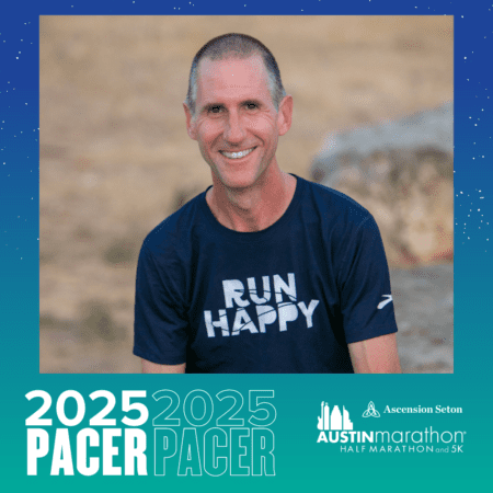 A smiling man with short hair is wearing a navy blue "Run Happy" t-shirt. He is sitting outdoors with a blurred background of grass and rocks. The image features text: "Meet Your 2025 PACER" and the "Austin Marathon Half Marathon and 5K" logo. Austin Marathon Half Marathon & 5K A smiling man with short hair is wearing a navy blue "Run Happy" t-shirt. He is sitting outdoors with a blurred background of grass and rocks. The image features text: "Meet Your 2025 PACER" and the "Austin Marathon Half Marathon and 5K" logo. Austin Marathon Half Marathon & 5K
