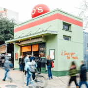Small green cafe with 'I love you' mural